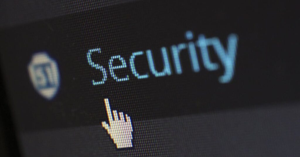 Close-up view of a mouse cursor over digital security text on display.